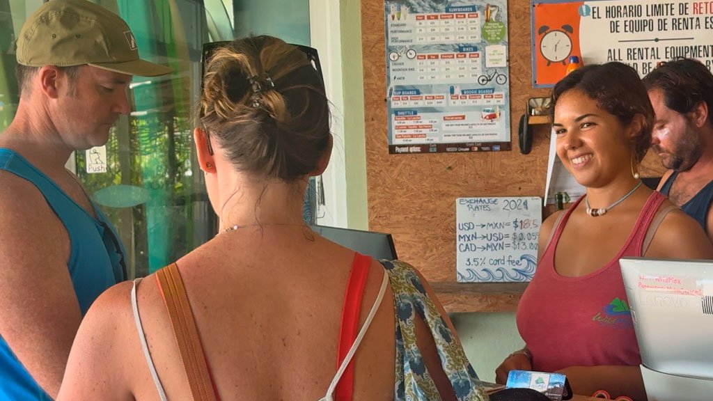 Front Desk Agent Job at Wildmex – Nayarit Mexico Wildmex front desk agent assisting couple of guests at reception in San Pancho Mexico